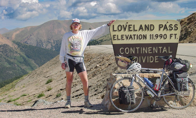 Man standing at the peak of Loveland Pass