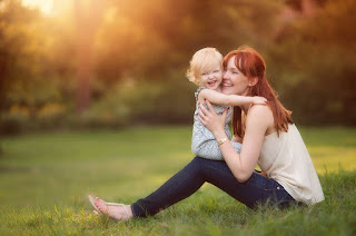 A lady laughing with her baby girl