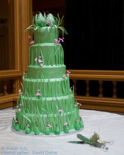 Amazing six tier wedding cake in a lovely green with tiny pink flowers