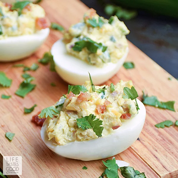 Jalapeno Popper Deviled Eggs | by Life Tastes Good. Can you imagine the goodness?! A deliciously tasty twist on Jalapeno Poppers loaded with cream cheese, fresh jalapeno, cheddar cheese, and BACON all stuffed into an edible dish you can eat with your hands! This might just be the perfect appetizer...