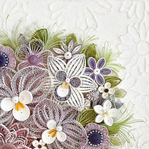 detail of quilled flower arrangement in shades of purple and white