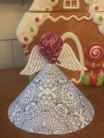 Print out this Adult Coloring page printable and make a fun Christmas angel for your Christmas party or book club.  This Printable angel craft comes together in moments and holds a yummy Tootsie Roll sucker for a sweet Christmas treat.