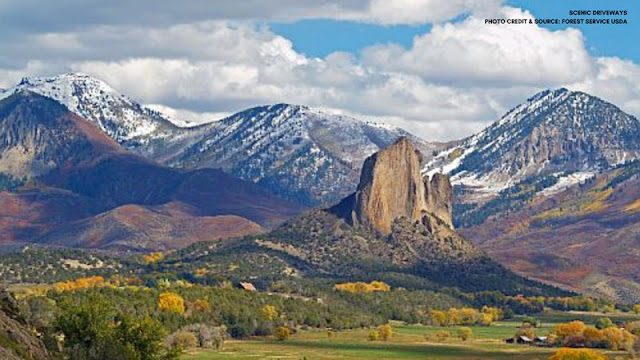 snowy mountains overlooking forest