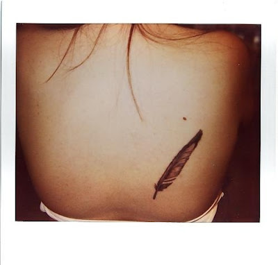 but never mind that Demi has a new TATTOO Its of a feather behind her