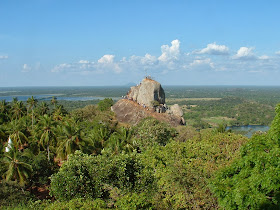 View on Mihintale, peak Aradhana Gala, pilgrims, Palm trees, Lake background, blue sky