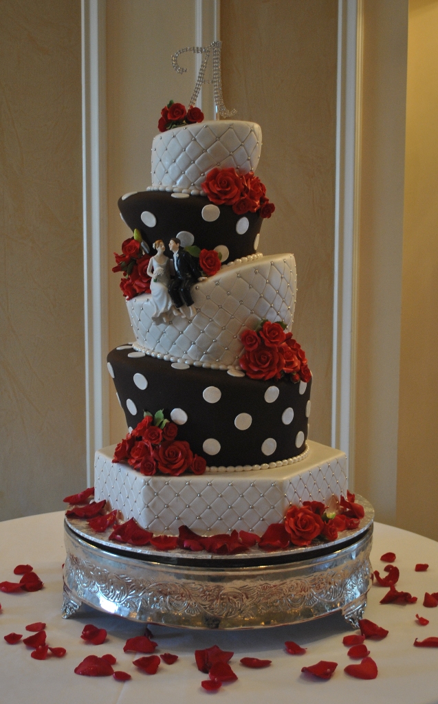 This 5tier black and white topsy turvy wedding cake is highlighted with red