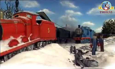 Edward blue engine pulled James train engine out the white deep snow on the cold chilly iron track