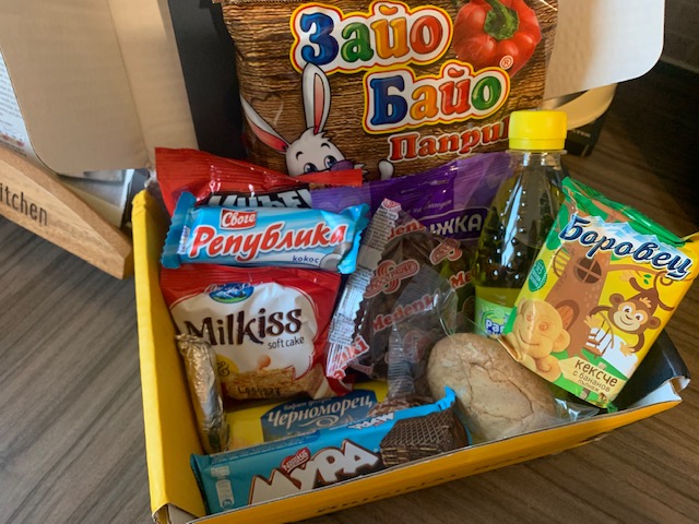 Cardboard box containing sweet and savoury packaged snacks from Bulgaria