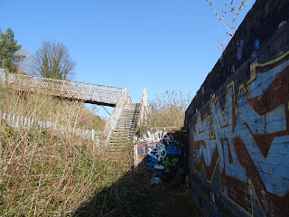 A photo showing the metal stairs leading up to the bridge over railway tracks at the back of the site.   Photo by Kevin Nosferatu for the Skulferatu Project.