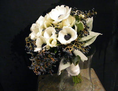 This allwhite winter wedding bouquet was created with Dusty Miller greens