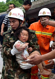 a rescuer carries a child in an earthquake sichuan china