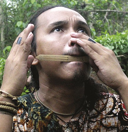 Palawan man playing the kubing or mouth harp