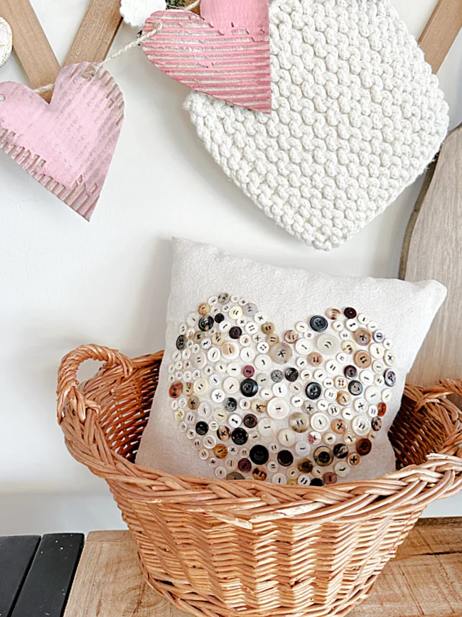 heart pillow with buttons in a basket