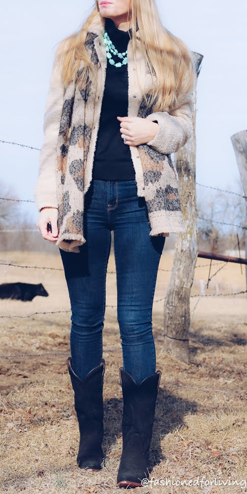 women black cowboy boots outfit with skinny jeans, teddy coat, and leopard scarf