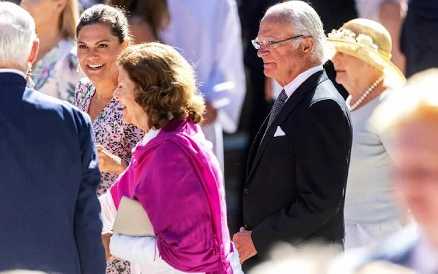 Crown Princess Victoria wore a floral print long-sleeve midi dress by Saloni. King Carl Gustaf and Queen Silvia