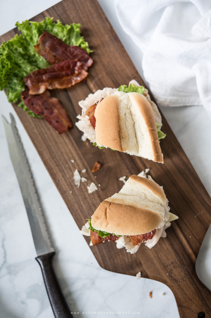 Turkey sub cut in half on cutting board