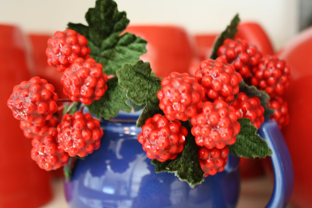 red berries in blue jug