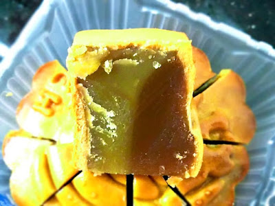 Pandan gula melaka mooncake with the pastes separated in two layers.