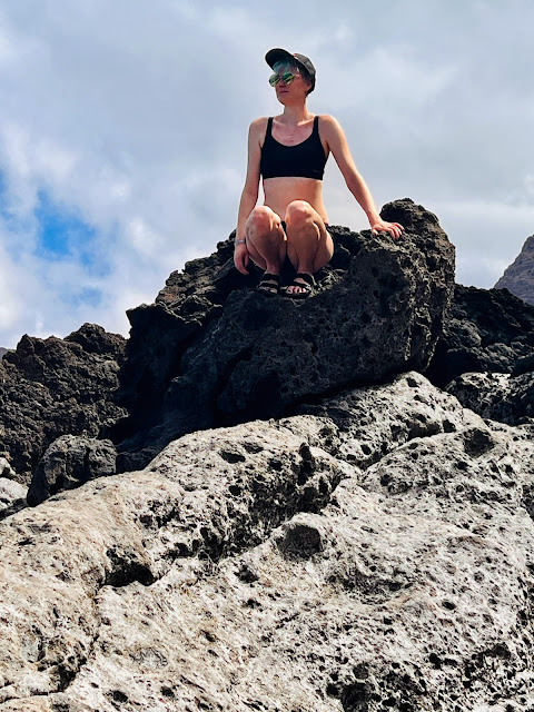 person sitting on volcanic rock, Tenerife
