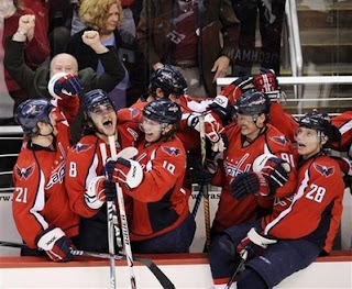 Washington Capitals head coach Bruce Boudreau (partially obscured), top left, pumps his fists in the bench area as Alex Ovechkin (8), of Russia, Nicklas Backstrom (19), of Sweden, Brooks Laich (21), Sergei Fedorov (91), also of Russia, and Alexander Semin (28), also of Russia, celebrate against the Florida Panthers during the final seconds of the third period of a NHL hockey game, Saturday, April 5, 2008, in Washington. The Capitals won 3-1. (AP Photo/Nick Wass) (Hey, who let the Swede and the Canuck in the photo?)