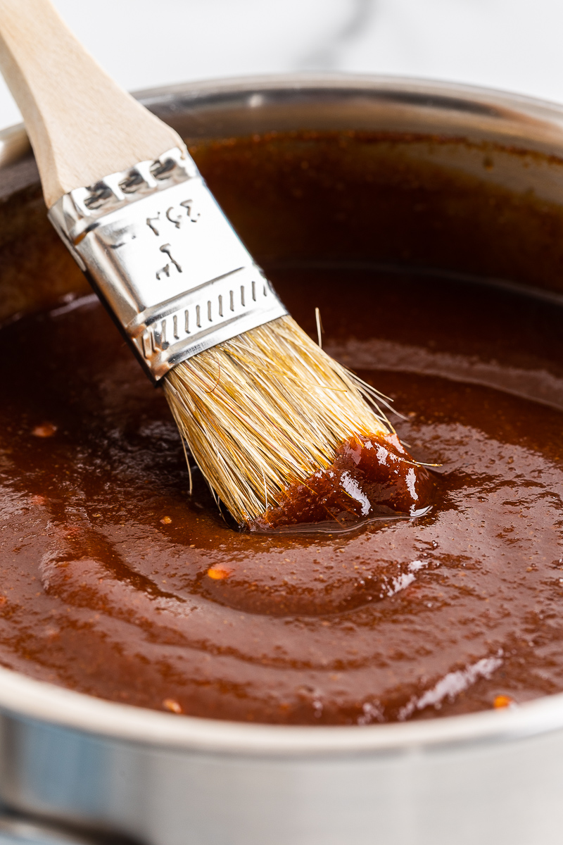 Keto BBQ sauce in a pot with a brush.
