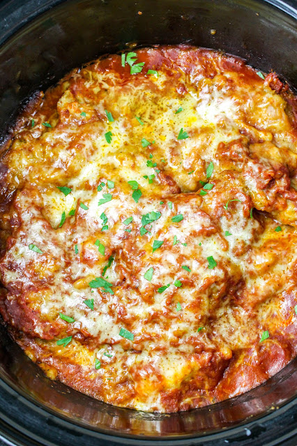 Chicken Parmesan in a black slow cooker.