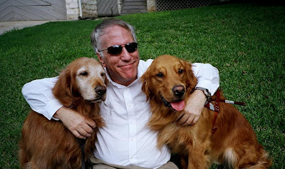 Morgan Watkins with his retired Guide Dog Fantom and his current Guide Dog Will, both Golden Retrievers