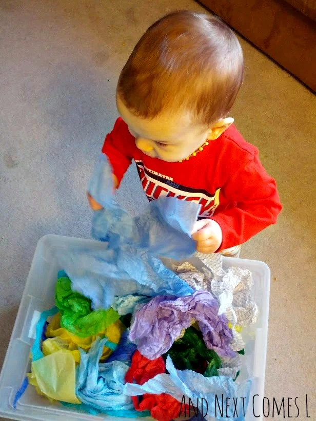 Simple toddler sensory bin using tissue paper from And Next Comes L