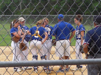 Coach Barbour huddles at the mound