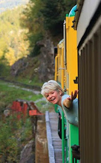 Photo of Brenda Wilbee leaning out the White Pass Train, taken by Blake Kent