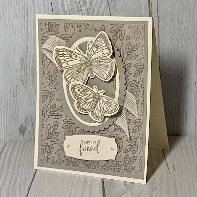 Two butterflies on a neutral card with open-weave ribbon