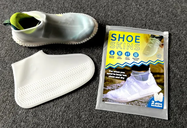 a transparent silicone shoe cover on a trainer, one next to the trainer and the shoe skin packaging