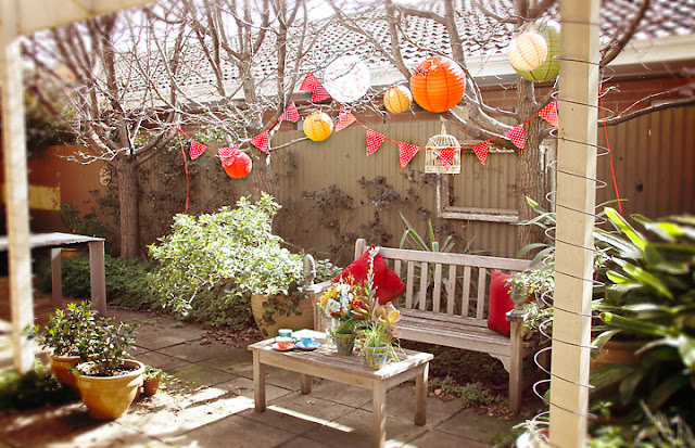 Colourful paper lanterns and garden setting - Perle Jewellery & Makeup