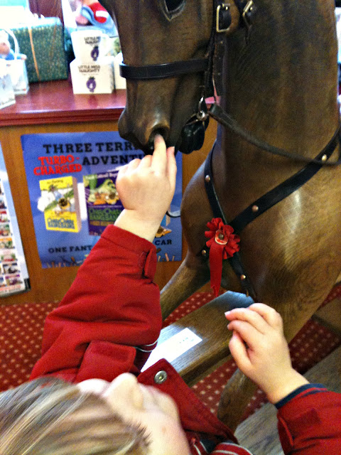 Picking a rocking horse's nose.