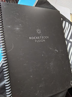 An older and grubby Rocketbook spiral bound notebook