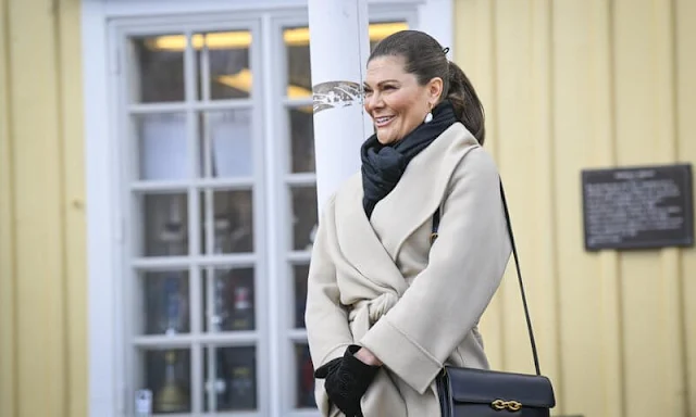 Crown Princess Victoria wore a maygen top, and a schain skirt by Baum und Pferdgarten, and a beige Robe belted wool coat by Toteme