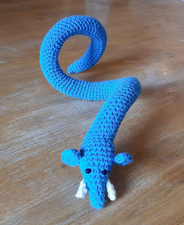 Blue crocheted snake with elephant ears and tusks