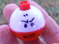 hand drawn electrode face on a red and white bobber