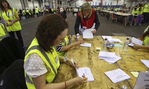 Election officials begin the counting process at a counting centre in Ingliston in Edinburgh, Scotland