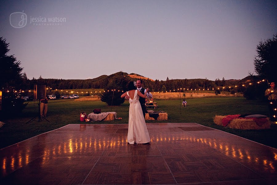  dance floor under the stars and twinkle lights with hay bail seating