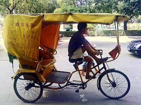 cycle rickshaw driver on road