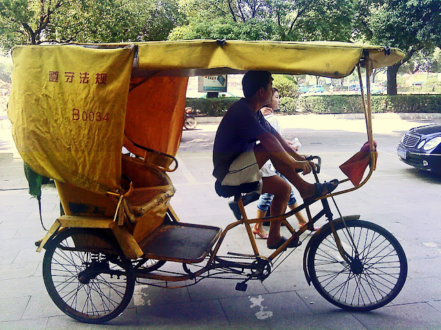 cycle rickshaw driver on road