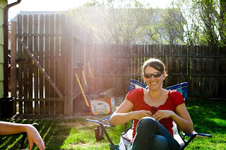 a woman smiling with sun flare