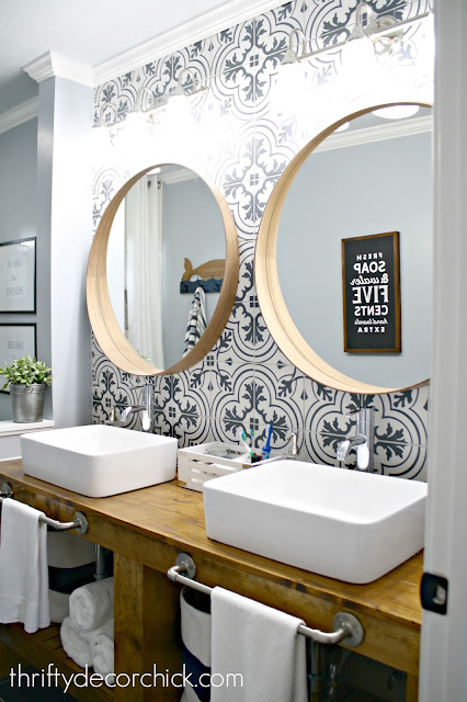 Bathroom makeover with wood vanity, vessel sinks and tile wall