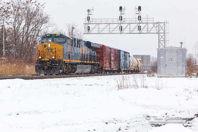 M364-25 is back on the move, passing under the westbound signal bridge at CP 286