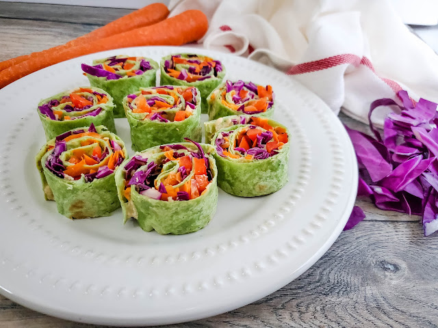Veggie Pinwheels on a white plate with a wood background.