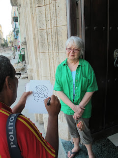 A street artist sketches our travel companion Virginia