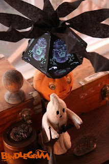 An autumn arrangement of found objects and limited Halloween art lantern by Bindlegrim