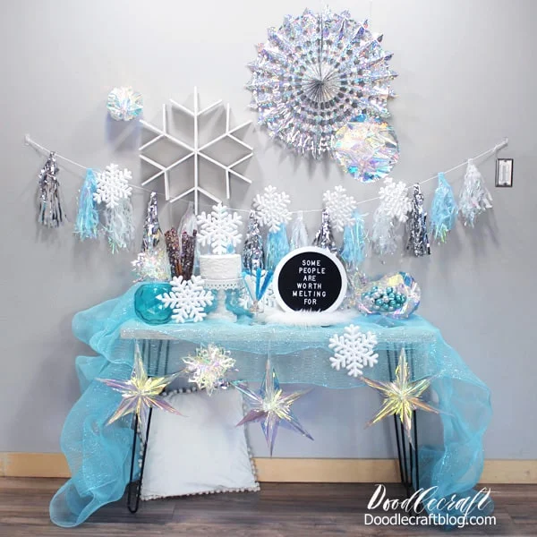 Frozen birthday party with silver and blue snowflakes, iridescent decorations, textures and lots of yummy food...plus becomes holiday decor for the Christmas tree after the party.