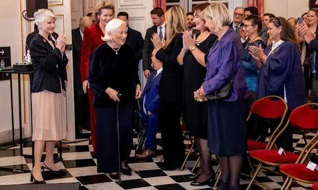 Queen Mathilde wore a new red velvet double-breasted blazer and red velvet trousers by Dries Van Noten. Queen Paola